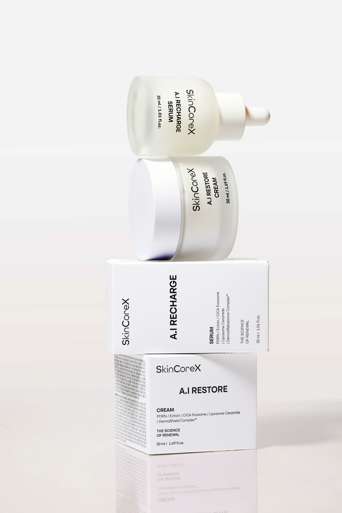 SkinCoreX A.I Recharge Serum bottle and A.I Restore Cream jar stacked on their cartons